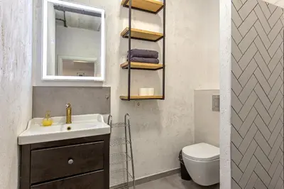 a bathroom with a sink and a toilet at Apartment near Vilnius Outlet in Vilnius