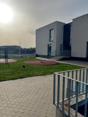 a building with a fence in front of a building at Apartment near Vilnius Outlet in Vilnius