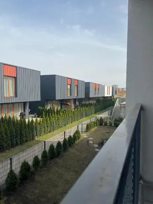 a view of a building with a row of trees at Apartment near Vilnius Outlet in Vilnius