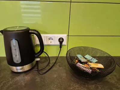 a coffee pot and a basket of food on a counter at Butas in Kaunas