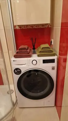 a washing machine with towels on top of it at Butas in Kaunas