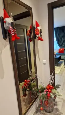 a mirror with christmas ornaments in a living room at Butas in Kaunas