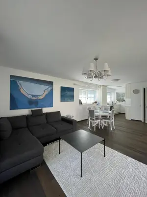 a living room with a couch and a table at Private Trakai Historical Centre Karaim Two Floor Apartment in Trakai