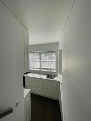 an empty kitchen with a sink and a window at Private Trakai Historical Centre Karaim Two Floor Apartment in Trakai