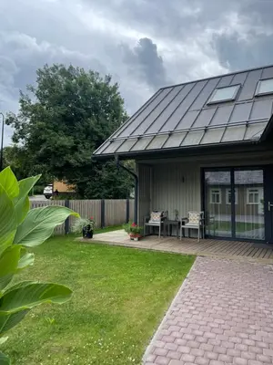 a house with a roof with a patio at Private Trakai Historical Centre Karaim Two Floor Apartment in Trakai