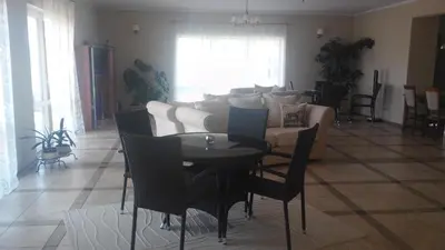 a living room with a table and a couch at Villa Cheval in Aukštadvaris