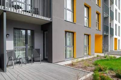 a balcony of a building with a table and chairs at No. 1 PARK AVENUE APARTMENT in Kaunas