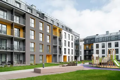 an apartment building with a playground in front of it at No. 1 PARK AVENUE APARTMENT in Kaunas