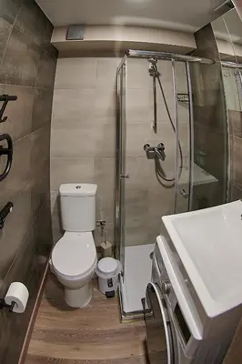 a bathroom with a shower and a toilet and a sink at Studio COZY VISIT, balcony, 24h self check-in, first floor, great location in Kaunas