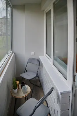 a small balcony with two chairs and a table at Studio COZY VISIT, balcony, 24h self check-in, first floor, great location in Kaunas