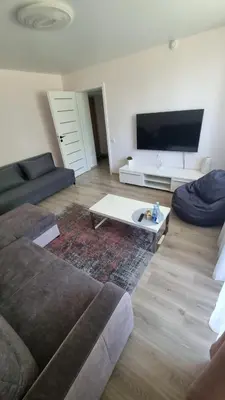 a living room with a couch and a coffee table at Trumpalaike buto nuoma in Rokiškis