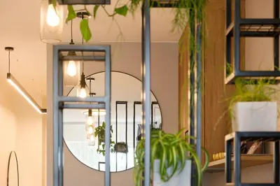 a mirror in a room with potted plants at Munu Holiday Apartments in Druskininkai
