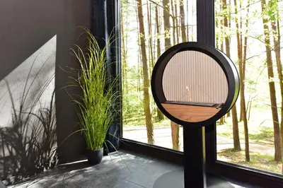 a mirror on a stand next to a window at Premium Forest Bungalow With Hot Tub & Sauna in Luokesos Sen