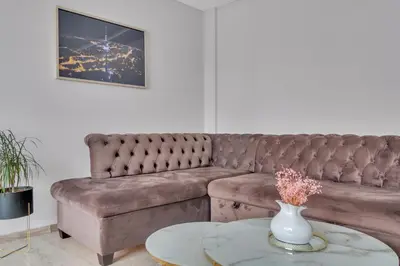 a living room with a couch and a table at Tower View Apartment in Vilnius