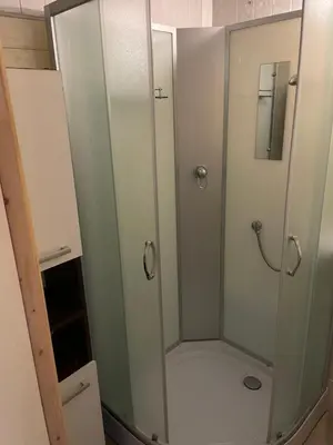 a shower with a glass door in a bathroom at Comfort home Šiauliai in Šiauliai