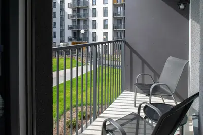 a balcony with chairs and a view of a building at No. 2 PARK AVENUE APARTMENT in Kaunas