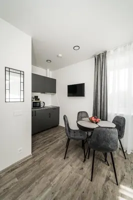 a kitchen and dining room with a table and chairs at Riverra House in Kaunas