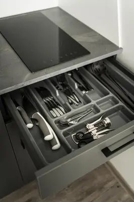 an open drawer in a kitchen with tools in it at Riverra House in Kaunas