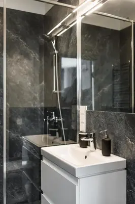 a bathroom with a white sink and a mirror at Riverra House in Kaunas