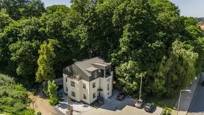 an overhead view of a house in the middle of trees at Riverra House in Kaunas