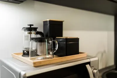 a counter with a blender on top of a microwave at Riverra House in Kaunas