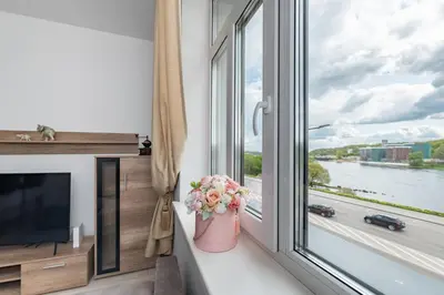 a room with a window with a view of a river at Serene Nemunas River View apartment near McDonald by Polo Apartments in Kaunas
