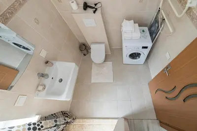 an overhead view of a bathroom with a toilet and a sink at Serene Nemunas River View apartment near McDonald by Polo Apartments in Kaunas