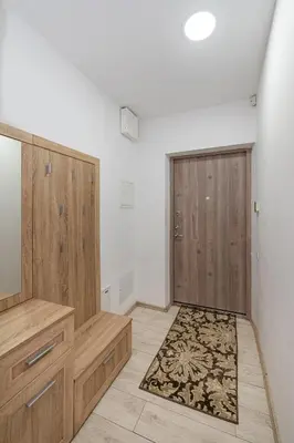 a room with two wooden doors and a rug at Serene Nemunas River View apartment near McDonald by Polo Apartments in Kaunas