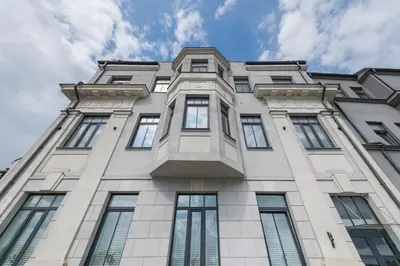 a tall building with windows and a blue sky at Serene Nemunas River View apartment near McDonald by Polo Apartments in Kaunas
