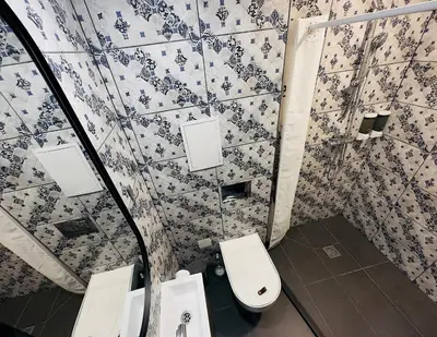 a bathroom with a toilet and two sinks at Broken bed hootel in Kaunas