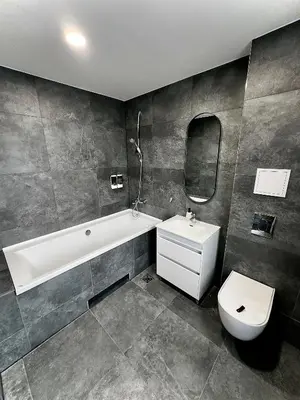 a bathroom with a tub and a toilet and a sink at Broken bed hootel in Kaunas