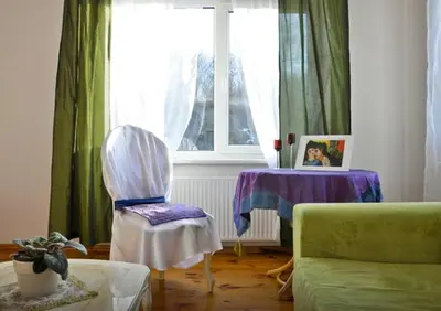 a living room with a chair and a table at Irena Family House in Vilnius