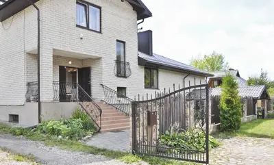 a house with a gate in front of it at Irena Family House in Vilnius