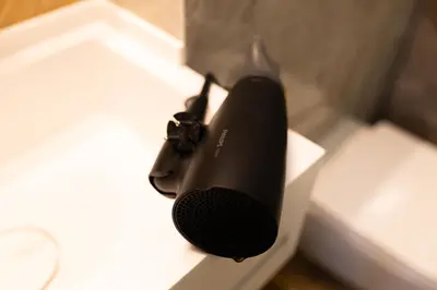 a black speaker sitting on top of a table at Four Sisters Luxury Rooms in Siauliai in Šiauliai
