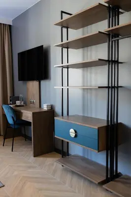 a room with a desk and a book shelf at Four Sisters Luxury Rooms in Siauliai in Šiauliai