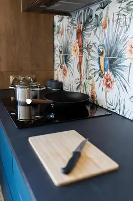 a kitchen counter with a cutting board and a knife at Four Sisters Luxury Rooms in Siauliai in Šiauliai