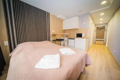 a bedroom with a bed with two towels on it at Vilnius Tiny apartments in Vilnius