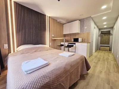 a bedroom with a bed with two towels on it at Vilnius Tiny apartments in Vilnius