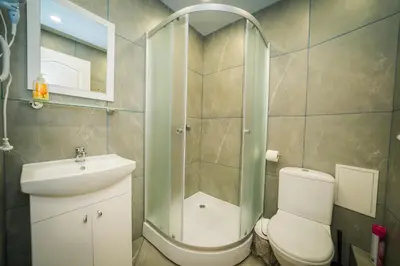 a bathroom with a shower and a toilet and a sink at Vilnius Tiny apartments in Vilnius