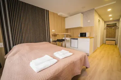 a bedroom with a bed with two towels on it at Vilnius Tiny apartments in Vilnius