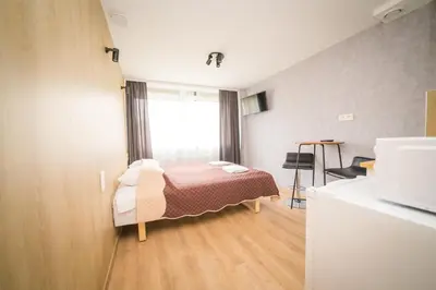 a small bedroom with a bed and a window at Vilnius Tiny apartments in Vilnius