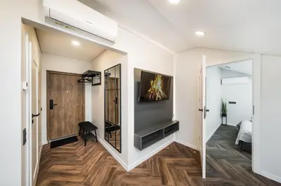 a living room with a large mirror and a tv at Riverra House - Two-bedroom Apartment in Kaunas