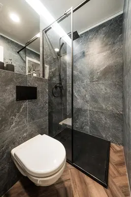 a bathroom with a toilet and a shower at Riverra House - Two-bedroom Apartment in Kaunas