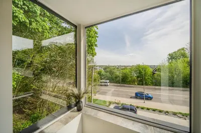 a large window in a room with a view of a street at Riverra House - Two-bedroom Apartment in Kaunas