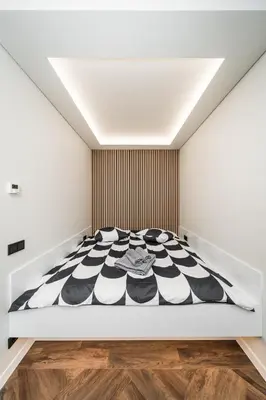 a bedroom with a black and white bed at Riverra House - Studio Panorama View in Kaunas