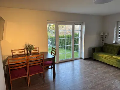 a living room with a table and chairs and a couch at Trakų Namelis in Trakai