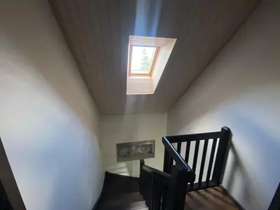a skylight in a room with a staircase with a window at Trakų Namelis in Trakai