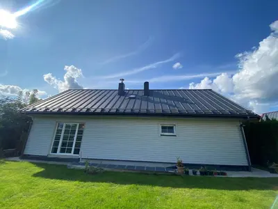 a house with a roof on top of a yard at Trakų Namelis in Trakai