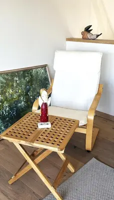 a wooden chair with a white pillow and a red bottle at Beautiful Vilnius with a terrace in Vilnius