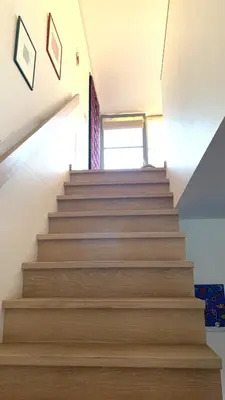 a staircase in a house with wooden steps at Beautiful Vilnius with a terrace in Vilnius